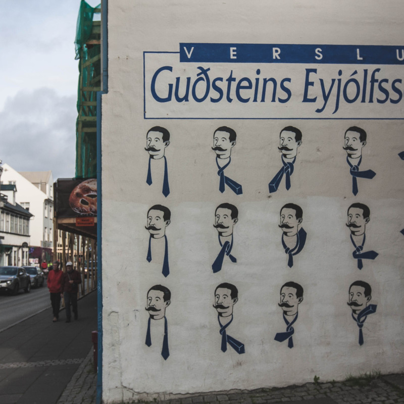 Eine Wand ist mit der Anleitung zum Krawatte binden angemalt.