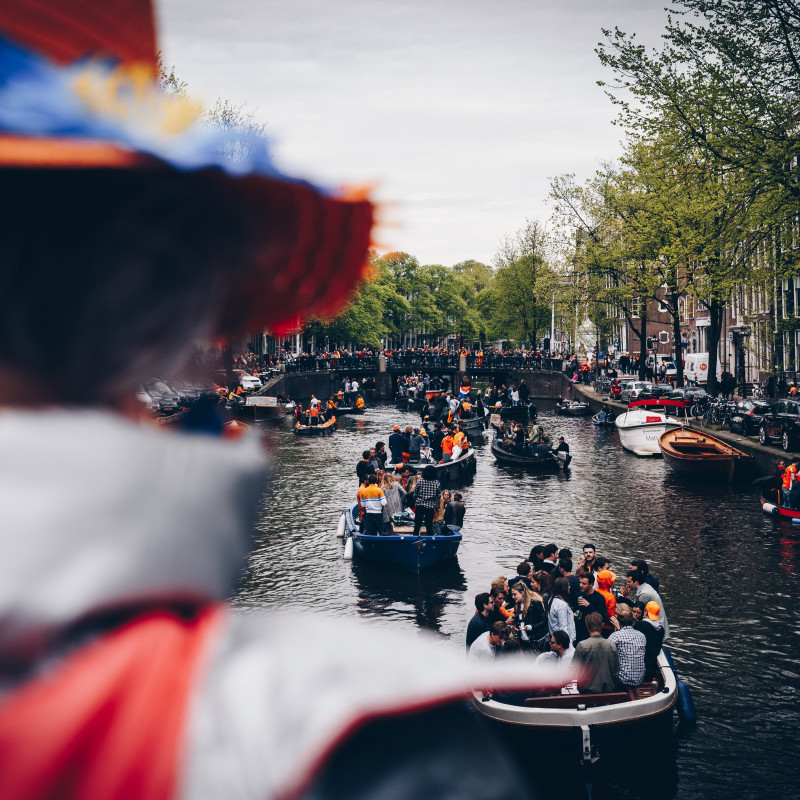 Boote auf Grachten am Königstag in Amsterdam.